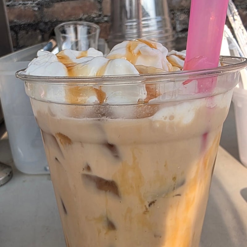 Iced coffee topped with whipped cream and caramel