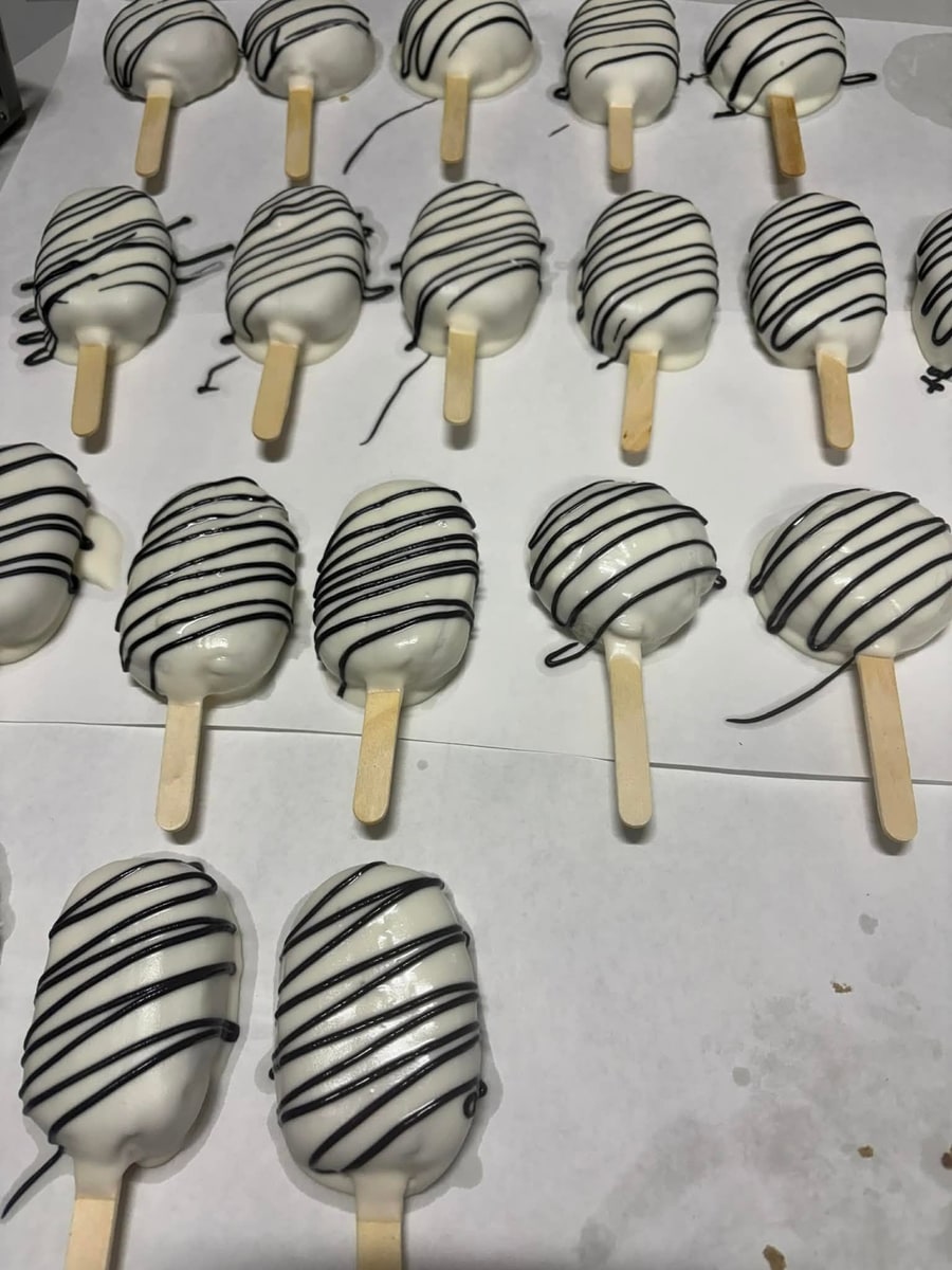 White chocolate cakesicles striped with dark chocolate drizzle