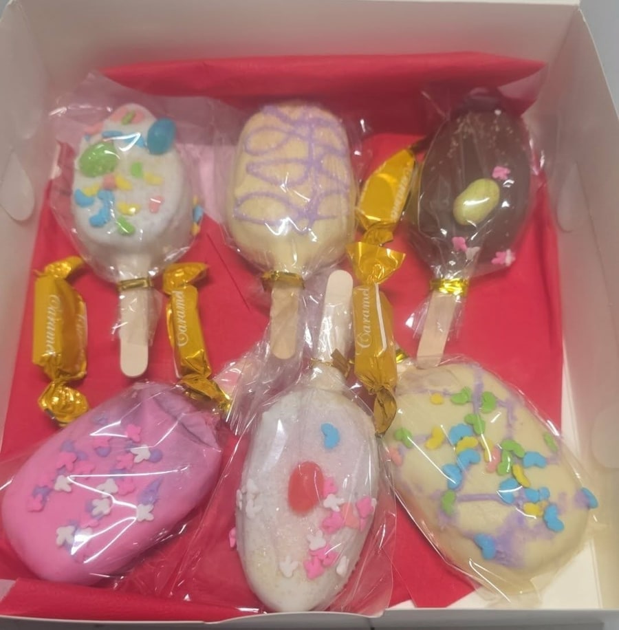 Easter box of pastel cakesicles with sprinkles and caramel candies